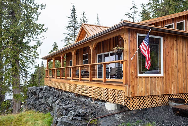 Picture of the Anglers Lodge showing the ocean view deck overlooking clover pass in Ketchikan, Alaska